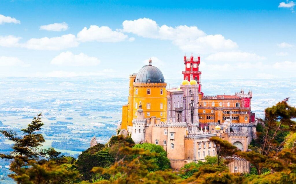 A fairy-tale castle on a hilltop (~€14 entry), with wild colors and turrets – it’s like Disney but real. The forests around are misty and magical; hike the trails for views. Day trip from Lisbon by train (~€4 round-trip) – worth the crowds for the wow factor.