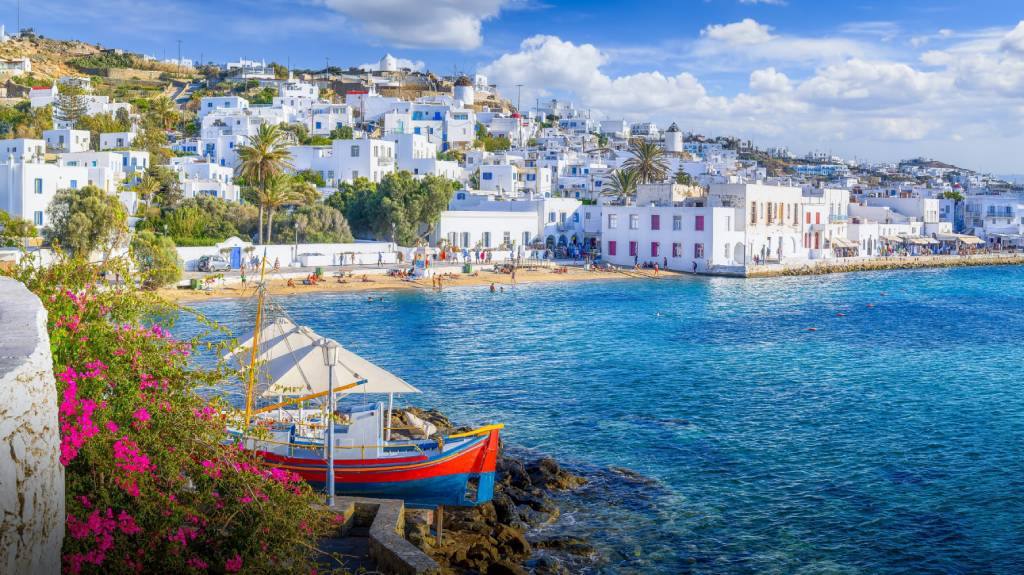Experience the cosmopolitan island of Mykonos! Explore Little Venice, the famous Windmills, and the vibrant nightlife. See the top 10 beaches, historical sites, and the best beach clubs.